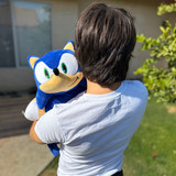 Little boy hugging the Sonic the Hedgehog Pillow Pet.