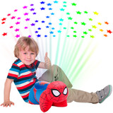 Little boy sitting beside the Spider-Man Sleeptime Lite while it projects colorful rainbow stars onto the ceiling.