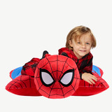 Child lying on the Jumbo Spider-Man Pillow Pet in pillow form, featuring Spider-Man's red and blue suit with black web detailing and large white eyes.