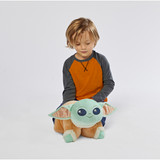 Child playing with the Baby Yoda Pillow Pet in plush character form.