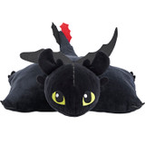 Jumbo Toothless Pillow Pet unfolded into an extra-large pillow, featuring the Night Fury dragon's black body, bright green eyes, wings, and red tail fin.