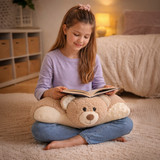 Lifestyle image of a little girl with a weighted Hiro Bear Pillow Pet on her lap, while she is reading