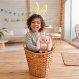 Lifestyle image of the cute pink Rosie the Bunny Boomeez being hugged by a little girl