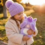 Lifestyle image of the cute lavender Pixie the Unicorn Boomeez being hugged by a little girl