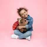 Strawberry Meadows Lulu the Ladybug Lifestyle Image of a little girl hugging Lulu the Laybug