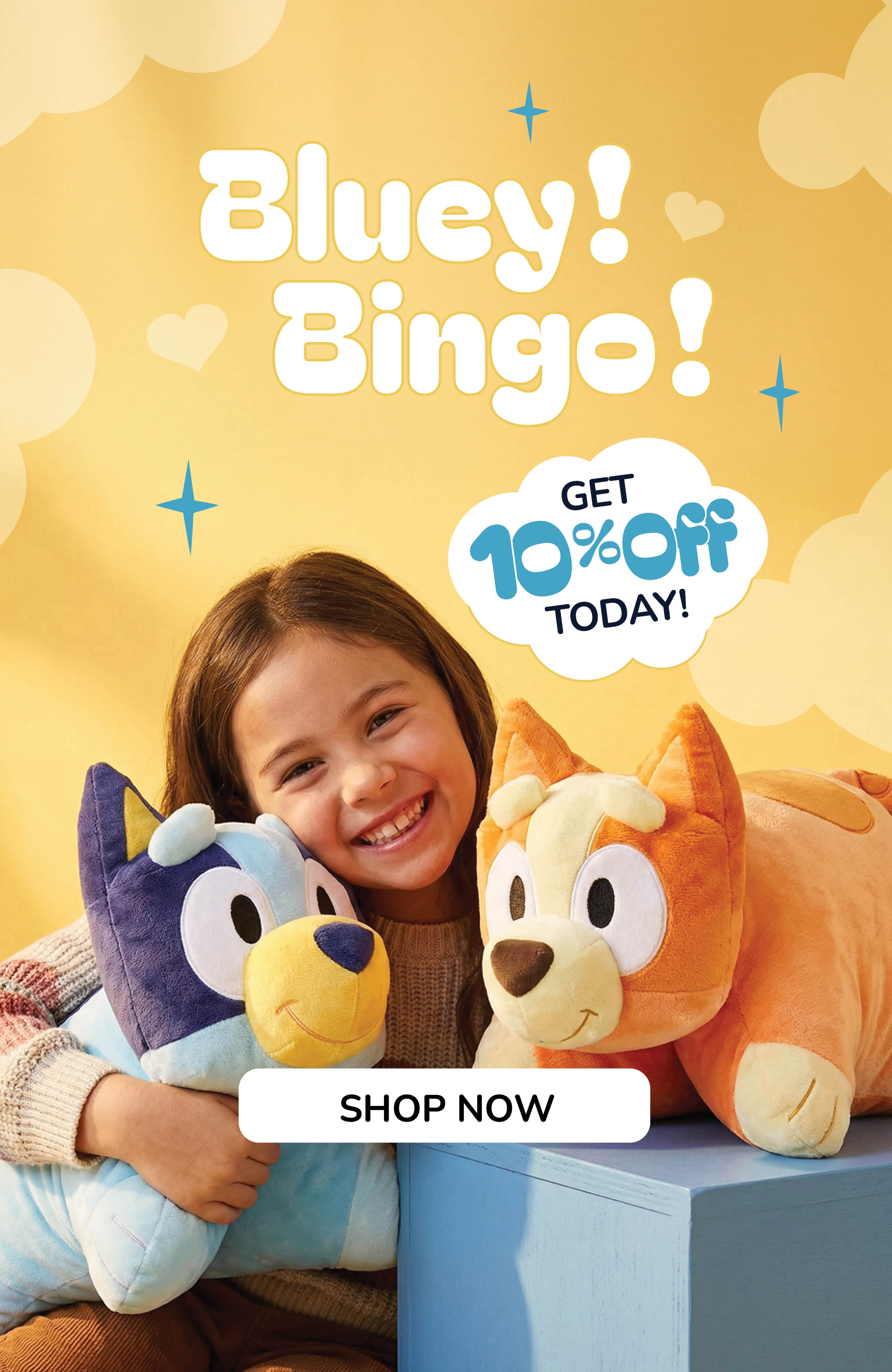 Little girl hugging the Bluey and Bingo Pillow Pets