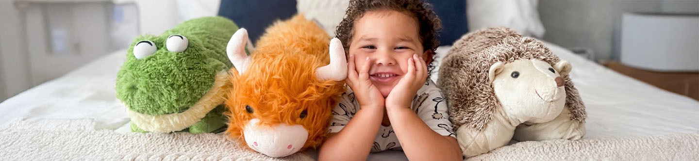 Title is Our Quality, and there is an image of a little boy with a frog, highland cow and hedgehog pillow pet.