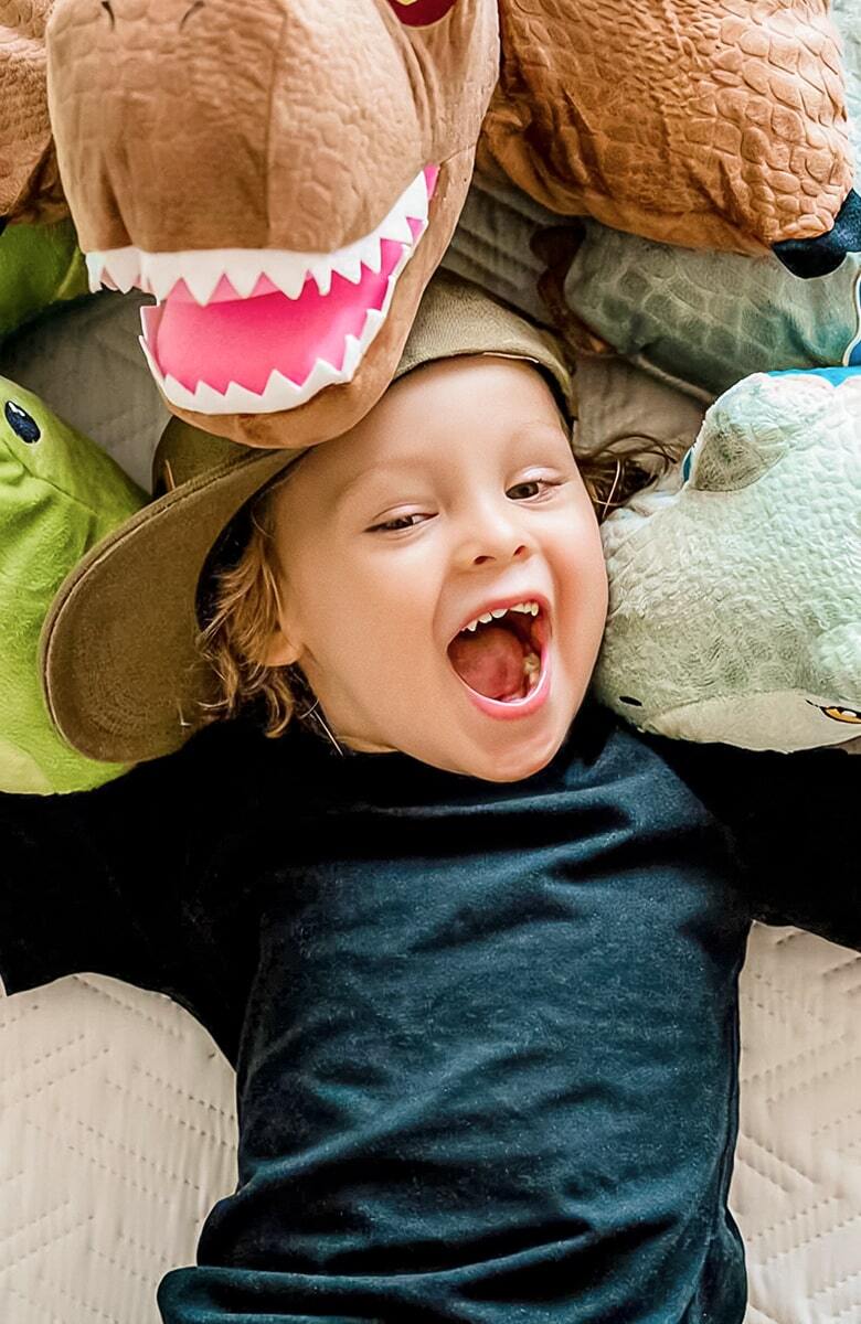 Child happily embracing Pillow Pets