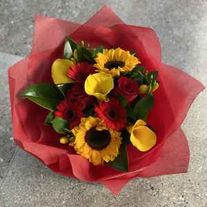 Vibrant reds and yellows in a hand tied bouquet