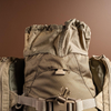 Top lid storage compartment of Eberlestock X2 open, revealing quick-access gear pocket.