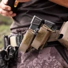KORE Essentials Swinger Mount double pistol pouches on battle belt with operator drawing pistol magazine
