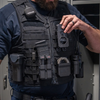 Close-up of a hand adjusting the Zero9 body cam case mounted on a tactical vest outdoors