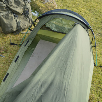Snugpak Stratosphere Bivvi olive interior view from above with 3/4-length side zip fully open showing bathtub groundsheet, sleeping mat inside, and mesh vent panel visible at head end with aluminum pole arch overhead
