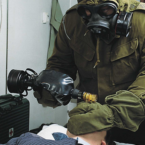 Ambu RDIC Military Mark III Resuscitator in operational scenario with responder manually ventilating adult patient.