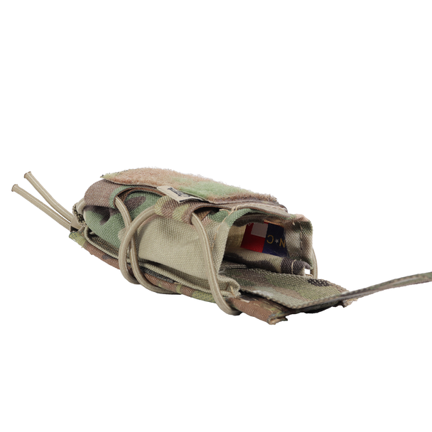 MultiCam High Speed Gear TACO tourniquet pouch lying on its side with a C-A-T tourniquet inside