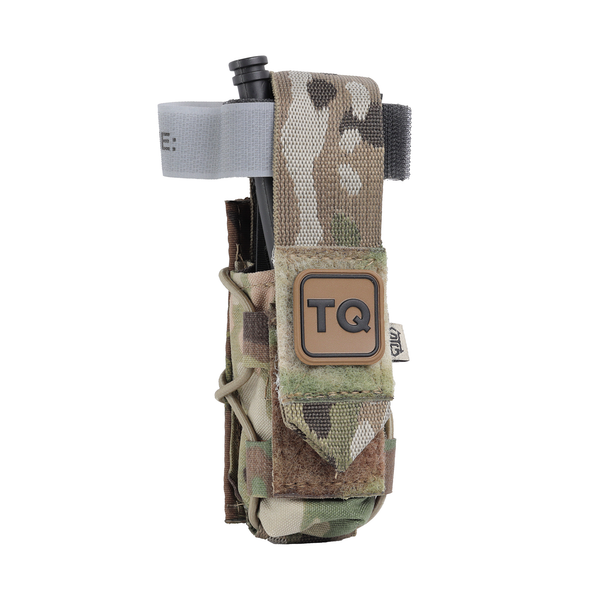 MultiCam High Speed Gear TACO tourniquet pouch with a C-A-T tourniquet stowed inside, front view with TQ label