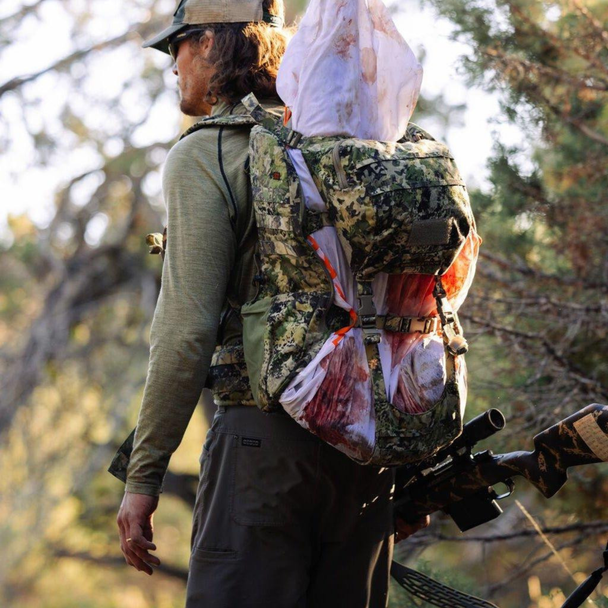 Profile shot showcasing the pack's streamlined load-bearing shape and dense fabric texture.