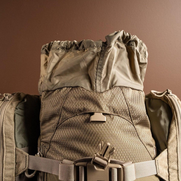 Top lid storage compartment of Eberlestock X2 open, revealing quick-access gear pocket.