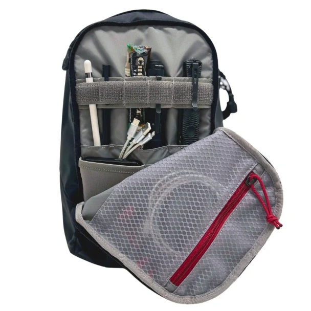 Vertx Urban Ghost Sling 10L VTX5304 gray mesh zip pouch close-up with red zipper pull and USB cable stored inside
