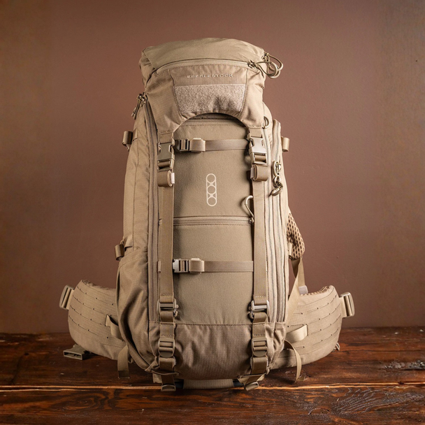 Front view of the Eberlestock Brute 3500 hunting backpack in tan color showing durable nylon frame and compression straps.