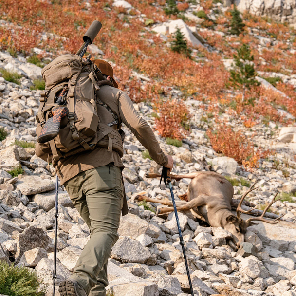 Backcountry hunter hiking with Eberlestock Brute 3500 pack during extended mountain hunt.