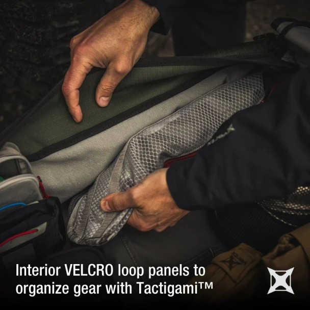 Vertx RLT 50L Duffel Bag VTX-VTX5096 Ranger Green interior VELCRO loop panels with hands organizing gear using Tactigami system
