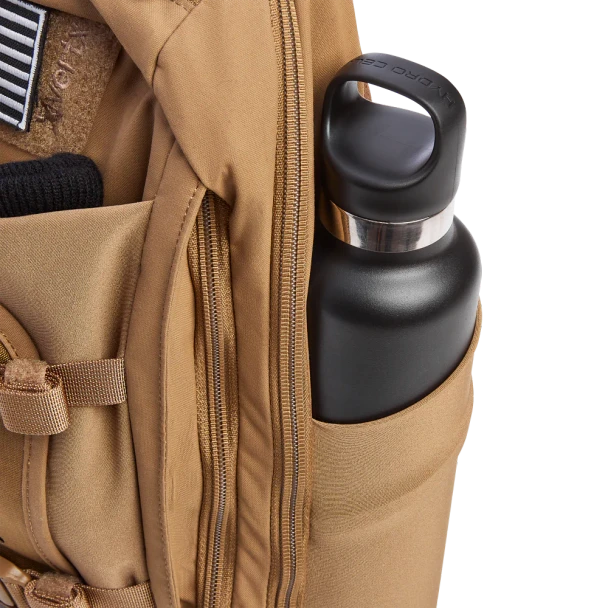 Vertx Siege 15L Sling Pack VTX5306 coyote brown close-up of stretchable side pocket with black water bottle fully seated and secure