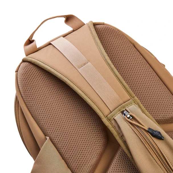 Vertx Siege 15L Sling Pack VTX5306 coyote brown back panel close-up showing padded mesh panel, top grab handle, and rear zip pocket with cord pull