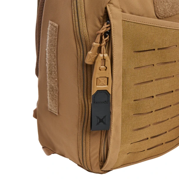 Vertx Siege 15L Sling Pack VTX5306 coyote brown side profile close-up showing laser-cut MOLLE webbing, main compartment zipper, and Vertx branded zipper pull tab
