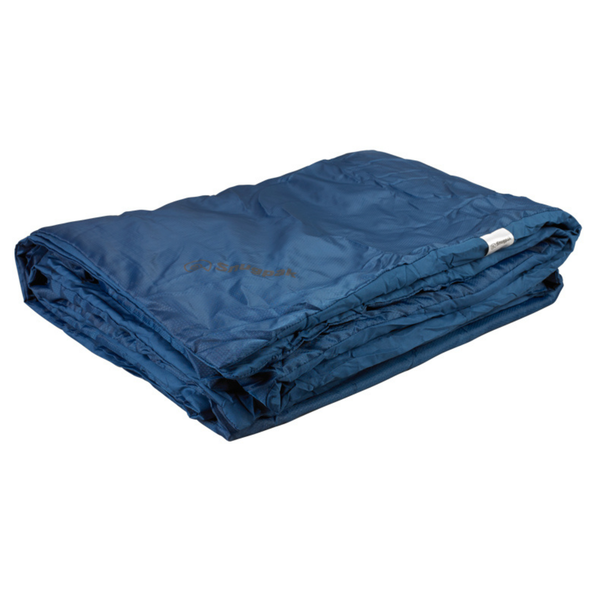 Snugpak Travelpak Blanket navy blue folded flat showing Snugpak logo printed on outer shell and care label tag visible at folded edge
