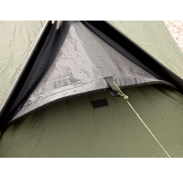 Snugpak Scorpion 2 IX olive close-up of rear vent opening showing water beading on wet flysheet fabric with guy line and stake-down tab detail visible at vent edge
