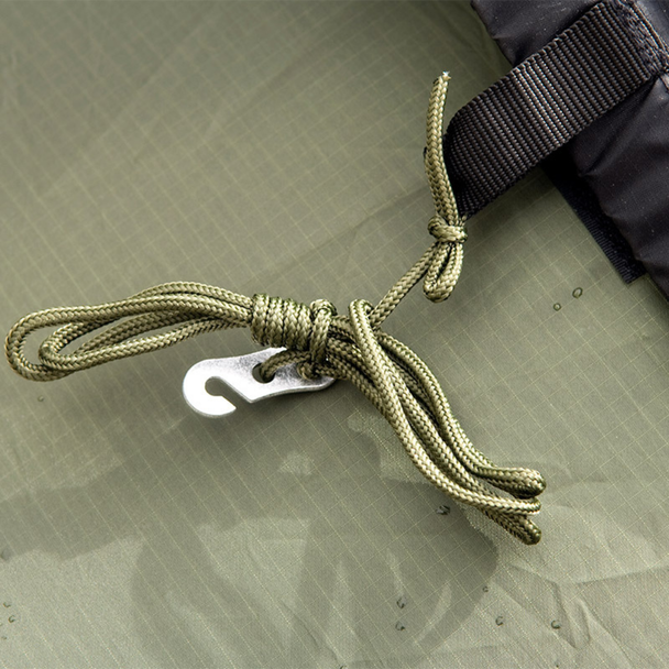 Snugpak Scorpion 3 IX olive close-up of rear vent opening showing water beading on wet flysheet with gray taped inner vent panel, guy line cord, and webbing stake-down tab at vent edge
