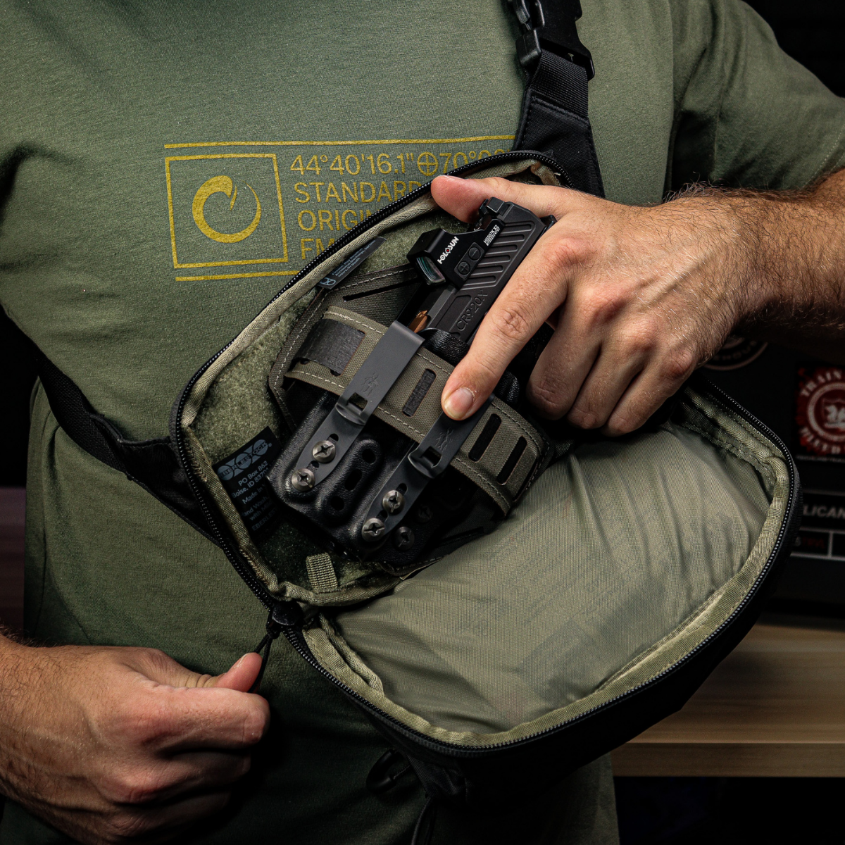 Drawing the pistol from inside the bag