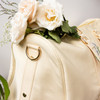 Close up of the side of the cream colored bag.