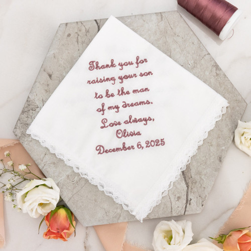 Handkerchief for the Mother of the Groom from her in law about her son to give on wedding day. Dainty white handkerchief with dusty rose embroidery thread. Floral shown for decoration.