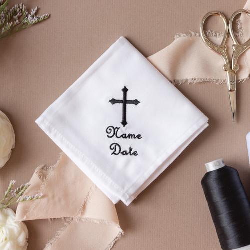 White handkerchief with embroidered cross and personalized name and date in the thread color of your choice.