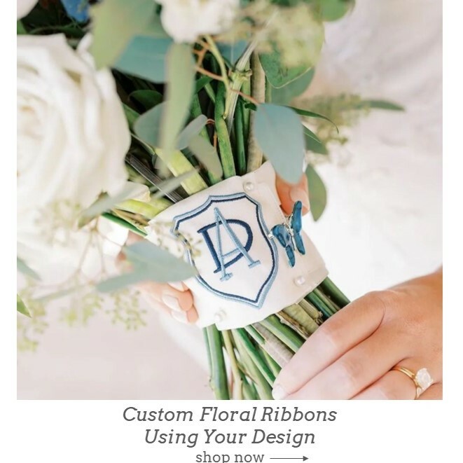 Floral wedding bouquet ribbon embroidered with bridal crest design in navy and blue.