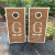 Custom rustic wedding cornhole boards featuring a woodgrain background, elegant monogram initial, personalized last name, and wedding date. Ideal for country, farmhouse, and outdoor weddings.