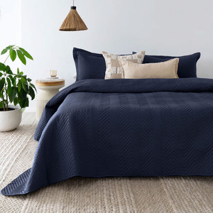Herringbone Embossed Coverlet Set in Navy styled on the bed Herringbone Embossed Coverlet Set in Navy styled on the bed