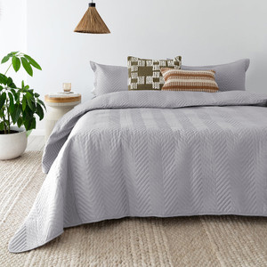 Herringbone Embossed Coverlet Set in Silver styled on the bed Herringbone Embossed Coverlet Set in Silver styled on the bed