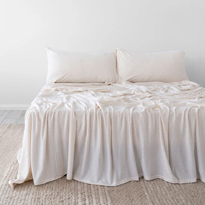 Stone colour Bambury BedT Organica sheets styled on a made bed, highlighting the smooth knitted finish and breathable drape Stone colour Bambury BedT Organica sheets styled on a made bed, highlighting the smooth knitted finish and breathable drape