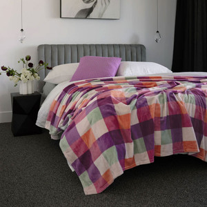 Charlie Ultraplush Blanket in Sherbet shown on a bed Charlie Ultraplush Blanket in Sherbet shown on a bed