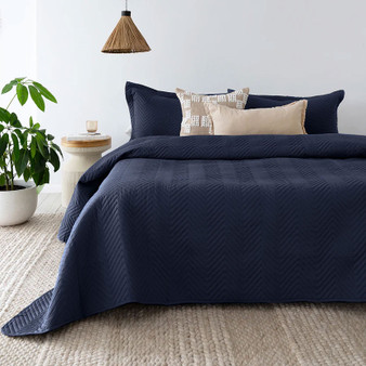 Herringbone Embossed Coverlet Set in Navy styled on the bed