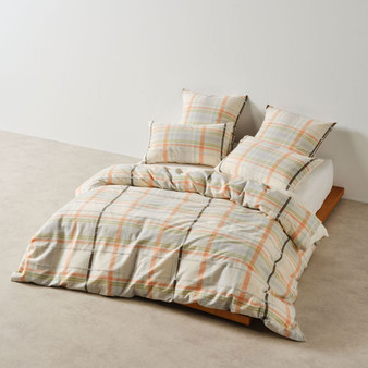 Linen House Hazelwood quilt cover on bed, showing green, blue, and apricot yarn-dyed check pattern