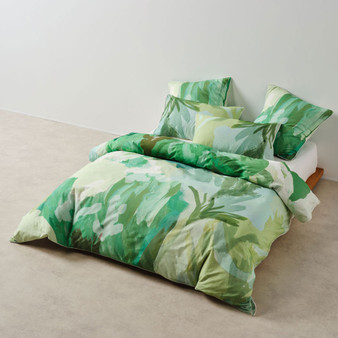 San Andreas quilt cover by Linen House styled on a bed, featuring hand-painted botanical design in forest and mint tones.
