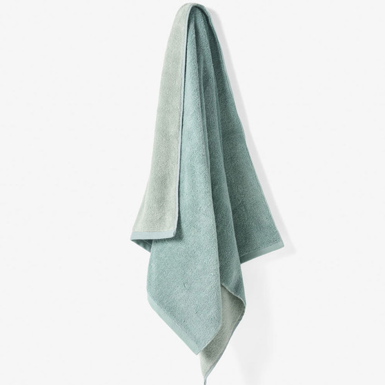 Linen House Otway Salt Water towel hanging to show dual colourway - lightweight, yarn-dyed cotton terry with soft texture.