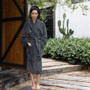Model wearing Bambury Microplush robe in Magnet (Dark Grey), showcasing its plush coral fleece texture and relaxed fit