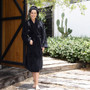 Female model wearing Bambury Microplush robe in Black, highlighting soft coral fleece fabric and easy fit