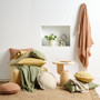 Maya by linen House lifestyle image of throws and cushions