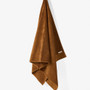 Linen House Marley rust towel hanging with chenille stripe detail